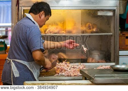 Singapore - 11 2018: Butcher At Work At Tekka Indian Market