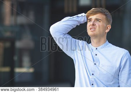 Portrait Of An Upset, Handsome European Guy, Looking Up, Formally Dressed In A White Shirt. Headache