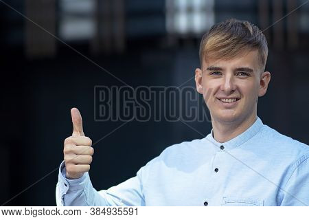 Handsome Male Businessman Smiling And Showing A Finger Gesture At The Top, Cool Sign. Happy Student 