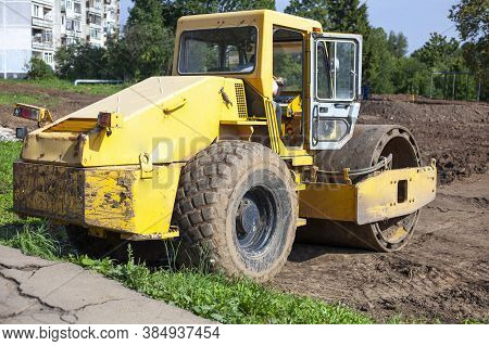 Bulldozer At A Construction Site. Heavy Construction Equipment. Sand Compactor. Multi-ton Diesel Car