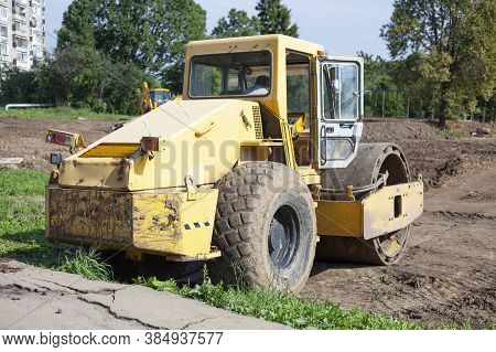 Bulldozer At A Construction Site. Heavy Construction Equipment. Sand Compactor. Multi-ton Diesel Car