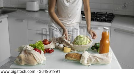 Woman Hand Holding Reusable Eco Textile Grocery Bag With Vegetables And Takes Cabage Out. Zero Waste