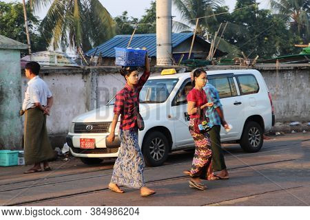 Yangon, Myanmar, Feb 24, 2019: Myanmese Woman With Thanakha (myanmar Powder) On Their Face Put The P