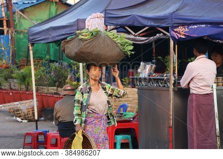 Yangon, Myanmar, Feb 24, 2019: Myanmese Woman With Thanakha (myanmar Powder) On Her Face Put Big Fab