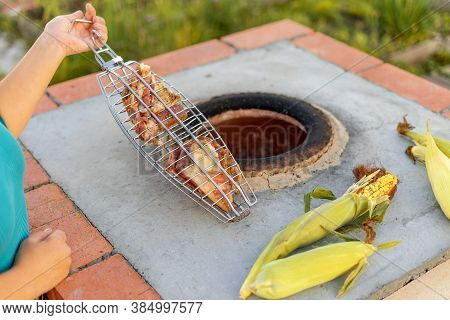Hands Of A Caucasian Woman Cooks Meat In A Tandoor. Skewers In The Tandoor. Cooking Meat Kebab In A 