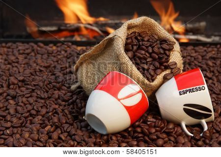 Two Cups Of Espresso And Coffee Beans On A Background Of Fire