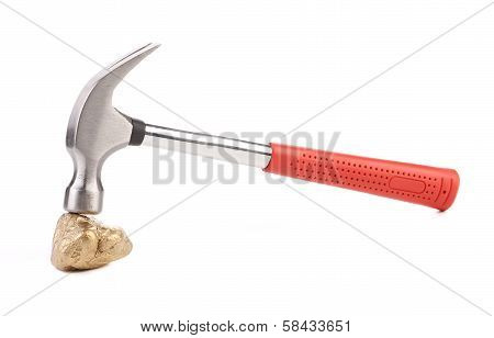 Close up of gold nugget and hammer.
