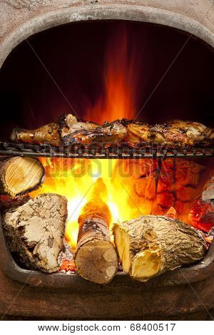 Barbecue chicken grilled over fire