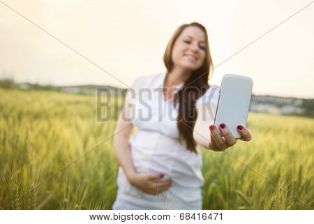 Pregnant woman taking selfie