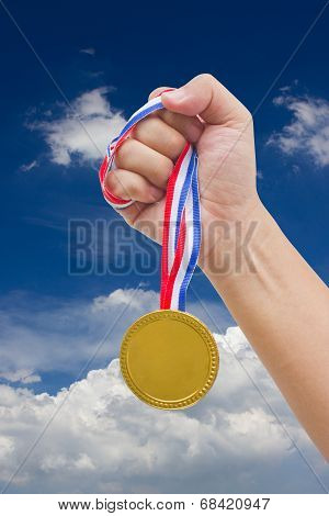 Golden Medal In Man's Hand Isolated On White Background.