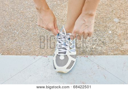 The Girl Tying Running Shoes.