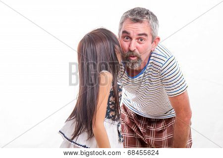 Girl Whispering In Dad's Ear