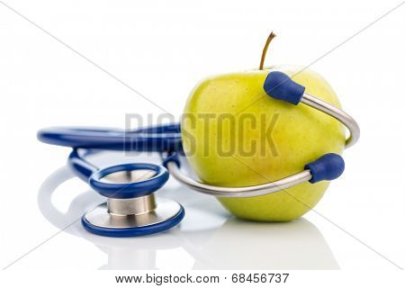 an apple and a stethoscope on a doctor. symbolic photo for healthy and vitamin-rich diet.