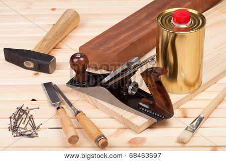 Carpentry tools on wooden background.