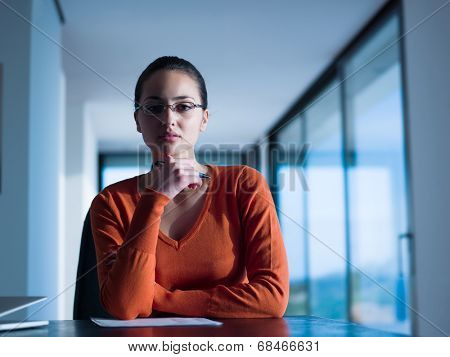 beautiful young woman relax and work on laptop computer while listening music on heaphones and read book at home