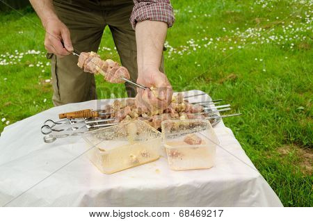 Man Put Skewer Green Pork Meat Cooking On Campfire