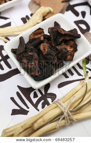 Traditional chinese herbal medicine ingredients on not real hieroglyphs, close-up