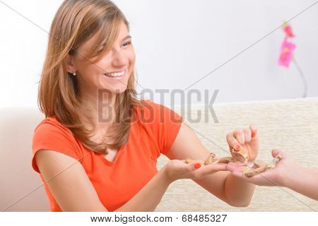 Young, smiling woman choosing her new deaf aid