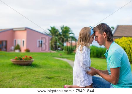 Happy father and his adorable little daughter outdoors
