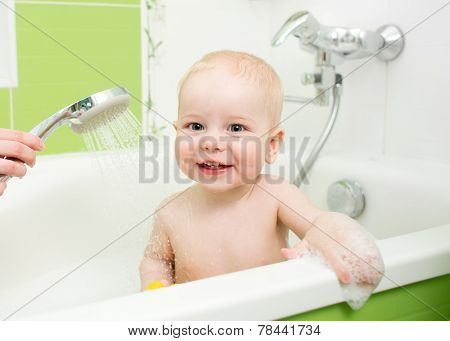 toddler boy taking a bath