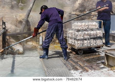 Worker Is Boiling Eggs In Mineral Water At Owakudani Valley