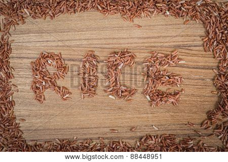 Brown Rice On Wooden Background