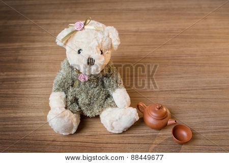 Toy Teddy Bear And Tea Kettle And Cup On Wooden Background