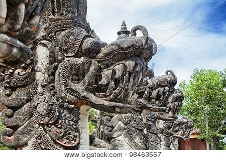 Traditional Balinese dragons in front of temple entrance
