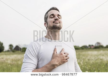 Happy young man in a field