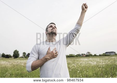Happy young man in a field