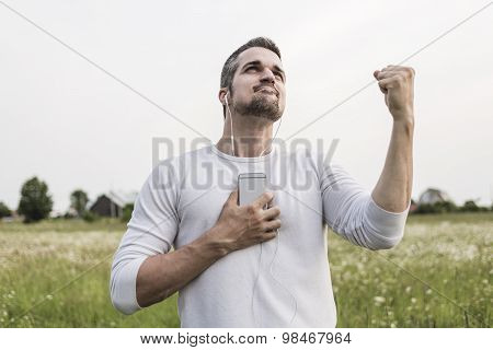 Happy young man in a field