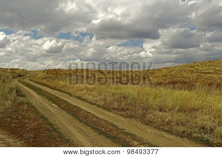 Steppe. Start of fall in  the steppe, golden and azure.The sky and hills. Steppe background. Steppe photo landscape. Nature background. Sky. Hills. Way.