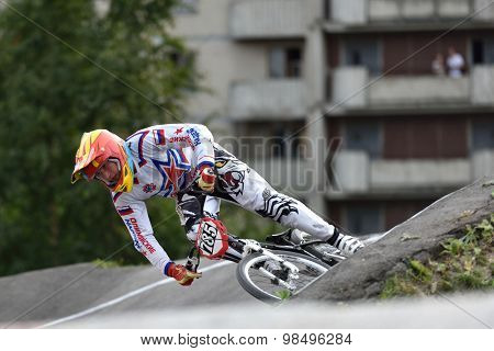 ST. PETERSBURG, RUSSIA - AUGUST 6, 2015: Unidentified biker on the berm in the BMX race Cruiser. The competitions is a stage of the BMX racing championship of Russia