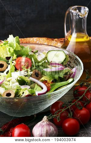 Bowl Of Salad With Vegetables And Greens On Wooden Table