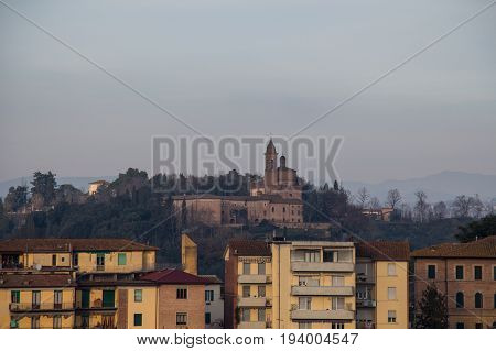 Italy Siena - December 26 2016: the view of typical old building in Siena and a church on background on December 26 2016 in Siena Tuscany Italy.
