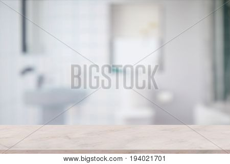 Products Display Concept. Empty pink marble top table for product display with blurred bathroom interior Bckground.