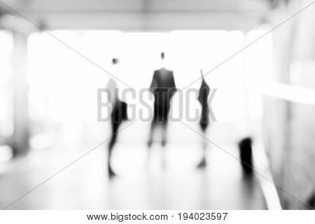 Blurred business people standing in the hallway can be used as abstract background