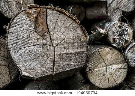 Abstract photo of a pile of natural wooden logs background dry chopped firewood logs ready for winter