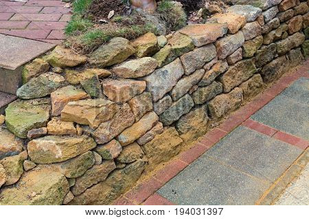 Wall of natural sandstone roughly cracked surfaces