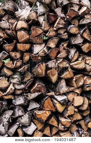 Abstract photo of a pile of natural wooden logs background dry chopped firewood logs ready for winter