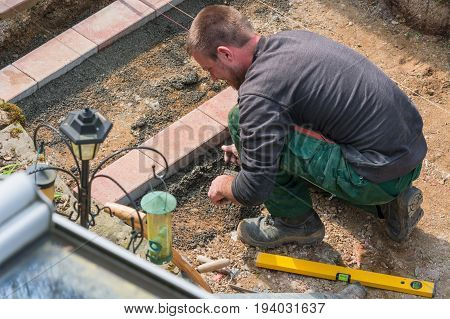 Close up construction worker in making a bricklayer from bricks on construction site.