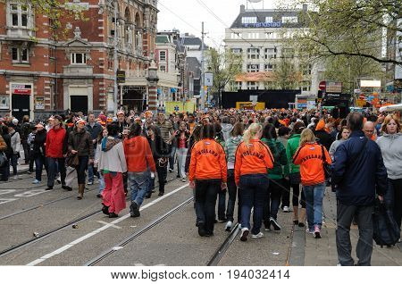 AMSTERDAM, NETHERLANDS - APRIL 30. Young People Celebrating Queensday in Amsterdam. Queensday is a popular annual festival celebrating the Queens Birthday.