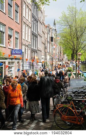 AMSTERDAM, NETHERLANDS - APRIL 30. Young People Celebrating Queensday in Amsterdam. Queensday is a popular annual festival celebrating the Queens Birthday.