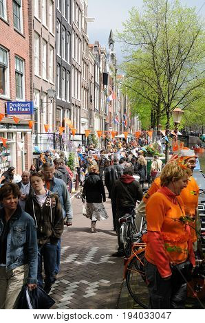 AMSTERDAM, NETHERLANDS - APRIL 30. Young People Celebrating Queensday in Amsterdam. Queensday is a popular annual festival celebrating the Queens Birthday.