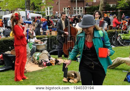 AMSTERDAM, NETHERLANDS - APRIL 30. Young People Celebrating Queensday in Amsterdam. Queensday is a popular annual festival celebrating the Queens Birthday.