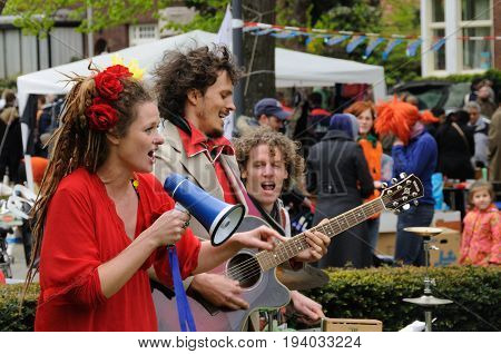 AMSTERDAM, NETHERLANDS - APRIL 30. Young People Celebrating Queensday in Amsterdam. Queensday is a popular annual festival celebrating the Queens Birthday.