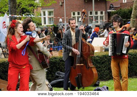 AMSTERDAM, NETHERLANDS - APRIL 30. Young People Celebrating Queensday in Amsterdam. Queensday is a popular annual festival celebrating the Queens Birthday.