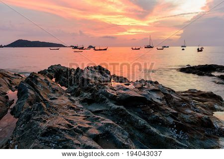 beautiful sunset and rock on the beach in phuket Thailand