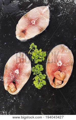 fresh scomberomorus fish placed on black slabs. In supermarket