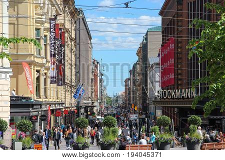 Helsinki, Finland - 28 Jun 2017: Pedestrian street in the centre of the city with many tourists and passers-by on the street with the shops and Stockmann Mall. Summer, Sunny weather